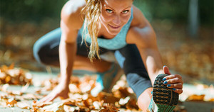 Woman stretching in the fall