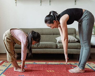 Mother and daughter stretching together