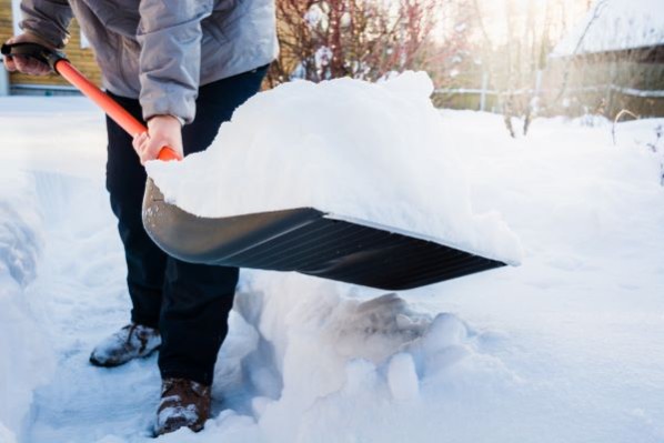 Man shoveling heavy snow