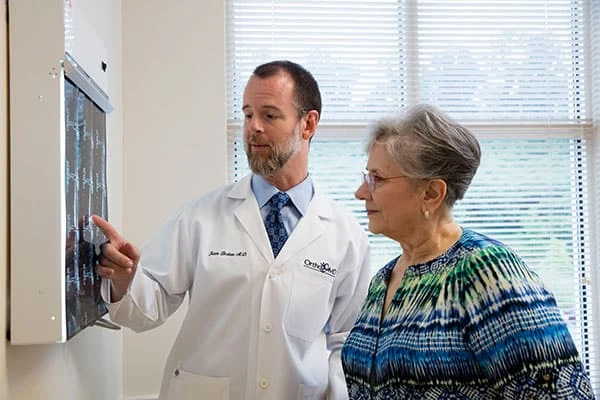 Dr. Brokaw showing patient spinal imaging